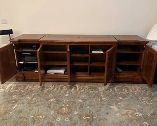 C111 - $1750. Sligh TV Lift Media Cabinet with Remote. Moves in 3 pieces. Each side piece is 24" wide x 27" deep x 34" tall. Center piece is 5' long x 28" deep x 34" tall. $1750. Sligh TV Lift Media Cabinet with Remote. Moves in 3 pieces. Each side piece is 24" wide x 27" deep x 34" tall. Center piece is 5' long x 28" deep x 34" tall. 