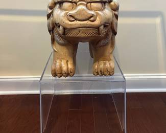 C42 - $450. Foo Dog Side Table. Glass top with lucite bases. Measures 66" x 15" deep x 28.5" tall. Dogs are porcelain material. 