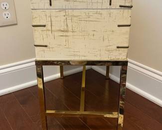 C15 - $175. Ivory Colored Lacquered Finish Chest on H Frame Brass Frame. Measures 18" wide x 10" deep x 18" tall. (Does NOT come off stand.) I believe this is Baker Furniture based on google results but the tag is missing. VERY sturdy piece. 