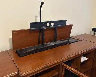 C111 - $1750. Sligh TV Lift Media Cabinet with Remote. Moves in 3 pieces. Each side piece is 24" wide x 27" deep x 34" tall. Center piece is 5' long x 28" deep x 34" tall. 