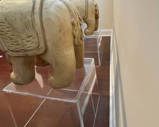 C42 - $450. Foo Dog Side Table. Glass top with lucite bases. Measures 66" x 15" deep x 28.5" tall. Dogs are porcelain material. 