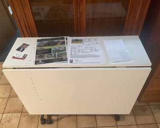 Large drop leaf table on casters.