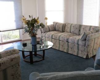 Matching sofas and Henredon round thick glass coffee table on solid wood frame.