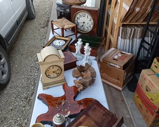 Antique clocks, clock parts, set of Andrea by Sadek fine porcelain candle sticks, hassock fan (works!), live-edge clock, antique soda table bench, whirly gig.