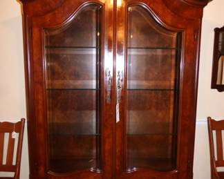 BURLED MAHOGANY BOMBE CABINET WITH GLASS SHELVES