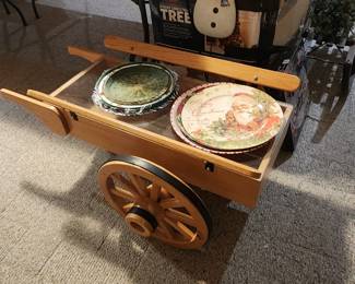 Coffee Table shaped like a wheelbarrow with large wagon wheels.  
