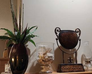 Vases - one with pheasant feathers, one with shells, and textured metal mantle art