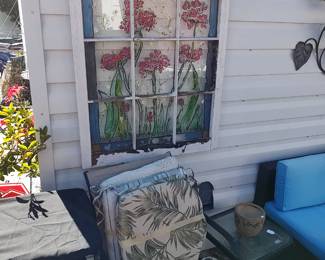 patio chair, cushions, bird feeder, faux stain glass window