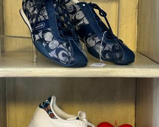 Gorgeous Coach Navy Designer Sneakers in Size 8.5, Shown with White and Paisley Striped Adidas Superstar Shoes, Size 8.5, a Cow Parade Figurine No. 7315, "Lady Camoolot" and a Brass and Leather Belt.