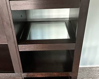 Detail View of the Gorman Media Center with Glass Insert Shelves and Pull-Out Drawers.