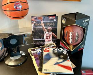 Exciting Selection of Sports Memorabilia Available Including a Detroit Piston's Basketball "Cookie Jar", Sports Illustrated "Basketball: A History of the Game" Book, and a NFL Wilson Official Game Ball 50th Anniversary, 1941-1991.