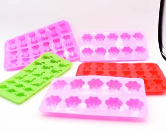 A Set of Five Flexible Silicone Molds with Paw Print, Bone, Teddy Bear, and Dinosaur Shapes

