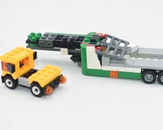 A LEGO Creator 3-in-1 Race Car Transporter (Set 31113) with an Additional Assembled Toy Vehicle
