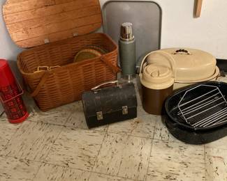 Picnic basket with serving pieces, thermos bottles, vintage lunch box, roasting pans