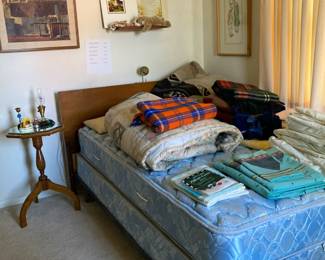 Blankets, sheets, comforter, side table, art