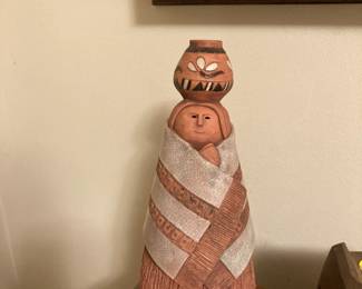 Pottery figurine woman carrying a jug