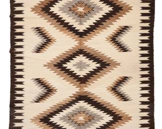 3237
A Nellie Glasses Navajo regional rug
Nellie Glasses (b. 20th century, Diné)
Mid/late 20th century
With stacked serrated diamonds and floating elements and an intricate long edge border, woven in dark brown, light brown, cream, and natural grey
88" H x 66.5" W
Estimate: $600 - $800