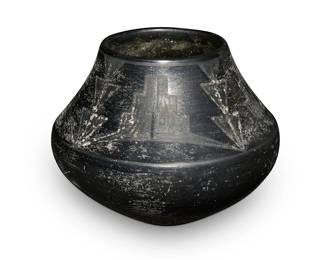 3303
Maria Martinez (1887-1980, San Ildefonso Pueblo)
A blackware pottery jar, circa 1920-1925
Incised to underside: Marie
The jar with black on black stepped and stacked triangle motifs to shoulder
5.5" H x 7" Dia.
Estimate: $300 - $500