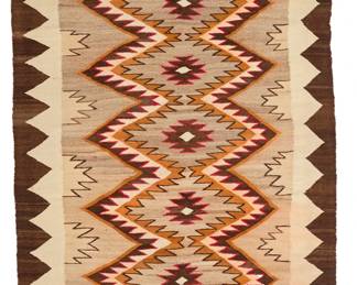 3252
A Navajo Red Mesa rug
Early 20th century, Diné
With a central column of stacked serrated diamonds within a sawtooth border, woven in red, cream, dark brown, tan, and orange wool
97.25" H x 49.5" W
Estimate: $700 - $900