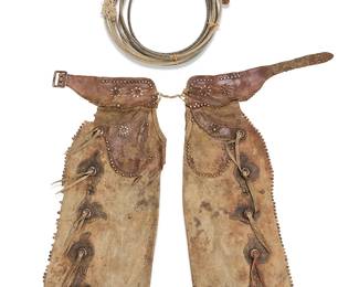 3246
A pair of Early American cowboy leather chaps and a lariat
Late 19th/early 20th century
The chaps with applied leather scrolled motifs to fronts with large metal rivets and hide lacings, the leather finished with scalloped edges with applied rivets, and the pockets and belt with cutout leather floral motifs, with a silver-toned buckle, together with a stiffened coiled rope lariat
3 pieces
Each leg: 39" H x 15' W approximately; lariat: 30" approximately
Estimate: $100 - $150
