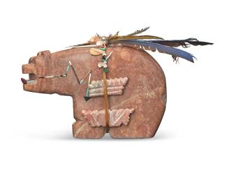 3373
Andy Abeita (b. 20th century, Isleta Pueblo)
A large carved hardstone bear fetish figure, late 20th/early 21st century
With artist's etched double 'A' cipher to underside
The bear fitted with carved shell teeth, featuring inlaid shell and turquoise heartline and mounted with offerings of carved stone, shells, and feathers, each side depicting incised katsina figures
Overall with feathers: 12" H x 21" W x 3.5" D
Estimate: $400 - $600