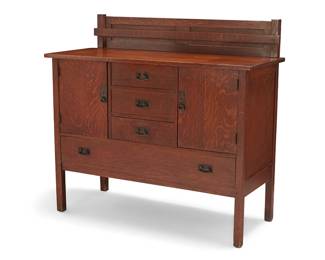 3075
An L. & J.G. Stickley oak sideboard, no. 734
1912-1917; Fayetteville, NY
With applied label: The Work of L. & J.G. Stickley
The quarter-sawn oak sideboard with hammered copper hinges, pulls, and hardware, featuring three middle drawers centering opposed locking cabinets above a long lower drawer, surmounted by a removeable plate storage rack
With dish rack: 44" H x 48" W x 20.75" D
Estimate: $800 - $1,200

