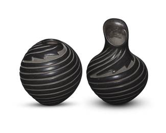 3309
Denise Chavarria (b. 1959, Santa Clara Pueblo)
Two blackware pottery vessels, late 20th/early 21st century
Each incised to underside: Denise Chavarria / Santa Clara
Each with deeply carved swirling motifs with a stepped motif at shoulder and slip painted carved areas, comprising a seed jar and a jar with long neck and shaped rim
2 pieces
Seed: 4" H x 3.75" Dia.; Shaped rim: 5.125" H x 3.625" Dia.
Estimate: $100 - $200
