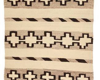 3207
A Navajo saddle blanket
Early 20th century, Diné
With alternating bands of crosses and diagonal ticking, woven in dark brown, natural grey, and cream wool
45.5" H x 29" W
Estimate: $400 - $600
