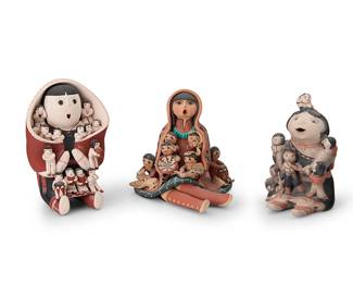 3187
A group of Southwest Pueblo pottery storytellers
Late 20th/21st century
Three works:

Felicita Herrera Eustace (1927-2016, Cochiti Pueblo)
A Cochiti Pueblo polychrome pottery storyteller
Signed to base: Felicita Eustace Cochiti Pueblo NM
With six children and a cat, with floral motifs to clothing
6.5" H x 4.25" W x 4.25" D

Carol G. Lucero Gachupin (b.1958, Jemez Pueblo)
A Jemez Pueblo polychrome pottery storyteller
Signed to one leg: Lucero Gachupin
The seated figure in slip painted red clay with a circle skirt and decorated mantle, with six children, a dog and a drum, a book, a scarf, and a decorated pottery bowl
6" H x 6.5" W x 8.25" D

Vangie Suina (b. 1959, Cochiti Pueblo)
A Cochiti Pueblo polychrome pottery storyteller
Signed to base: Vangie Suina / 12/89
A tall finely painted figure wearing a large red decorated mantle or wearing blanket, and holding fourteen children
7.25" H x 5" W x 5"D

3 pieces
Estimate: $200 - $400