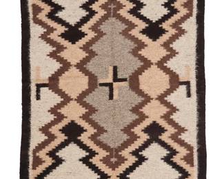 3235
A Navajo regional rug
Mid/late 20th century, Diné
Woven in brown, tan, grey and black wool with a central sawtooth diamond and half diamonds to sides, with two-color cross motifs and a black border
54.5" H x 39.5" W
Estimate: $400 - $600