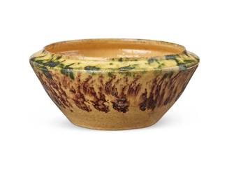 3086
George E. Ohr (1857-1918)
A small glazed earthenware bowl, early 20th century
Impressed to underside: GEO E OHR / BILOXI MISS
With mottled green and brown on a yellow ground glaze
2" H x 4.375" Dia.
Estimate: $800 - $1,200