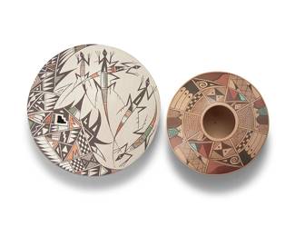 3371
Two Southwest Pueblo polychrome pottery seed jars
Two works:

Judy Lewis (b. 1966, Acoma Pueblo)
A polychrome seed jar with lizard motif, late 20th/early 21st century
Signed to underside: J. Lewis / Acoma
The multi-color pot with offset aperture in the shape of kiva steps and decorated with lizard and geometric motifs on a white slip ground
1.75" H x 5.5" Dia.

Nona Naha (1958-2021, Hopi-Tewa)
A polychrome pottery seed jar, early 21st century
Signed to underside: Nona Naha [corn cipher]
With multi-color geometric motifs to low shoulder on a cream slip ground
1.875" H x 4.25" Dia.

2 pieces
Estimate: $200 - $400