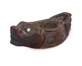 3297
A Northwest Coast carved cedar grease bowl
20th century
A sea lion form wooden bowl with shell disc eyes and diminutive shell inlay to back flippers
2.5" H x 4.25" W x 8.5" D
Estimate: $400 - $600