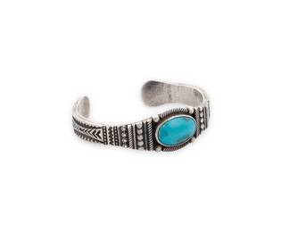 3375
A Southwest Navajo sterling silver and turquoise cuff bracelet
Late 20th/21st century
Stamped with pictograph for Monsterslayer shop, N.M.; further stamped: Navajo / Sterling
A chunky cuff with a central set turquoise cabochon and a variety of silver overlay and stamped motifs
7" total inner C x 0.875" H, with a 1.125" gap
53.9 grams gross
Estimate: $200 - $400