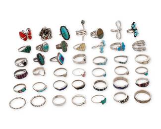 3390
A group of Southwest-style silver and stone set rings
Mid/late 20th century
Seven variously marked for maker: DG / NN / EY / I.Mc / P.D. Coonsis / L. Bennett [for Lee Bennett, Navajo/Diné] / F [or H] S/Zuni; nine marked for sterling
A large group featuring various stones including turquoise, coral, mother of pearl, lapis, and onyx, in various styles including bezel-set, cluster-set, mosaic inlay, and silver overlay
42 pieces
Ring sizes: 10 to 4.5
131.6 grams gross
Estimate: $200 - $400