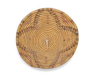 3293
A polychrome Jicarilla Apache basketry tray
Mid-20th century; Southwest United States
A coiled tray with stepped star motif and stepped triangles to rim
3.75" H x 14.75" Dia.
Estimate: $200 - $300