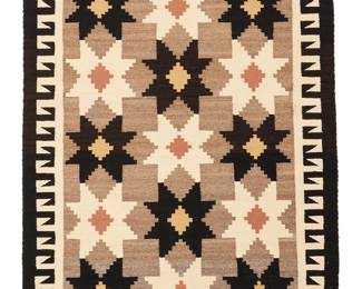 3242
A Navajo regional rug
Late 20th/21st century, Diné
Woven in natural grey, black, cream, tan, and ochre wool in an all-over stepped star pattern with hooked borders to sides
47.5" H x 34.5" W
Estimate: $300 - $500