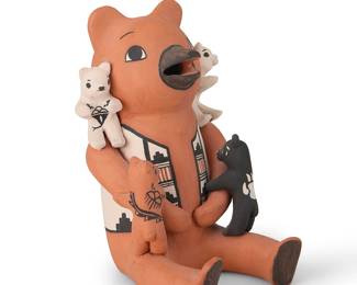 3394
Edwin Herrera (b. 1966, Cochiti Pueblo)
A Cochiti Pueblo polychrome pottery storyteller bear figure
Signed to base: Edwin Herrera / Cochiti, N.M.
The primarily redware bear with four cubs in white, red and black, with multiple bear paw motifs and a decorated vest
7.75" H x 5.25" W x 6.25" D
Estimate: $100 - $200