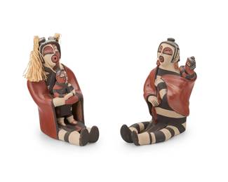 3405
Matthew Fragua & Reyes Panana (1963-2015 & b. 1961, Jemez Pueblo)
Two Jemez Pueblo polychrome pottery storytellers, late 20th/21st century
Each variously marked: M. Fragua / R. Panana / Jemez
Comprising a Reyes Panana Koshare figure designed with contrast black, white, and red with corn husk tassels holding a child (7.25" H x 4.25" W x 6" D), together with a M. Fragua and R. Panana similar Koshare-style figure with earrings holding a child in a blanket (7" H x 4" W x 6.5" D)
2 pieces
Estimate: $200 - $400