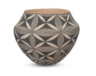 3350
Nelda Lucero (b. 20th century, Acoma Pueblo)
A fine-line pottery olla, late 20th century
Signed in slip to underside: N. Lucero / Acoma
With black bands of foliate and fine-line motifs over a white buff slip ground, above a puki indentation to underside
8.625" H x 10" Dia.
Estimate: $300 - $500