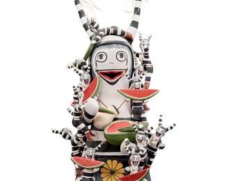 3327
Tony Dallas (b. 1956, Hopi Pueblo)
A Hopi Pueblo polychrome black and white Koshare clown storyteller, late 20th/21st century
Signed to underside: Tony Dallas / Hopi
The seated figure with thirteen children, many eating and holding watermelon slices
10.5" H x 5.5" W x 6" D
Estimate: $100 - $200
