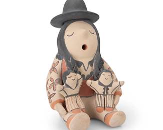 3388
Mary Tapia Trujillo (1937-2021, Ohkay Owingeh/San Juan Pueblo) & Leonard Trujillo (1936-2017, Cochiti Pueblo)
A Cochiti Pueblo polychrome pottery storyteller figure
Signed to base: Mary & Leonard Trujillo / Cochiti Pueblo
With two children, a large black hat and braided hair, wearing a floral jacket
7.75" H x 5.25" W x 6" D
Estimate: $200 - $300