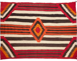 3196
A Navajo Third Phase variant wearing blanket
Late 19th century, Diné
With central serrated concentric diamond, a banded ground, and serrated corners, woven in dark brown, natural brown, cream, red, dark orange, and pale orange wool
66.5" H x 86" W
Estimate: $3,000 - $5,000
