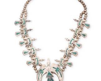 3381
A Navajo sterling silver "Peyote Bird" squash blossom necklace
Late 20th century
Stamped: A.J.
A double strand sterling silver squash blossom-style necklace with ten turquoise mosaic chip inlay "anhinga" or peyote bird "blossoms" and a central anhinga/peyote bird naja
25" L x 3.625" H
183.3 grams gross
Estimate: $700 - $900