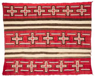 3192
A Navajo wearing blanket variant with spider woman crosses
Early 20th century, Diné
Woven in 4-ply Germantown wool with rows of red spider woman crosses alternating with natural cream and dark brown bands
63" H x 75" W
Estimate: $7,000 - $9,000