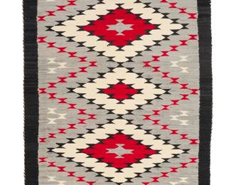 3267
A Navajo regional rug
Mid-20th century, Diné
Woven in red, grey, black, and cream wool with a column of five stacked conjoined diamonds and a black border
61.5" H x 32" W
Estimate: $200 - $400