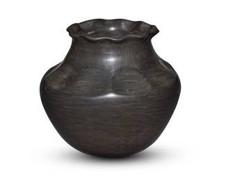 3305
Sharon Naranjo Garcia (b. 1951, Santa Clara Pueblo)
A large blackware pottery jar, late 20th/early 21st century
Incised to underside: Sharon Naranjo Garcia / Santa Clara Pueblo
The stone burnished jar with piecrust rim that slopes down the neck to form lobes at the shoulder
8.75" H x 9.75" Dia.
Estimate: $400 - $600