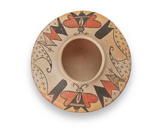 3333
Mark Tahbo & Grace Chapella (1958-2017 & 1874-1980, Hopi-Tewa)
A polychrome yellowware pottery jar, mid/late 20th century
Signed to underside: Mark Tahbo / Grace Chapella
The three-color jar with red and dark brown moth figures, stars, and geometric motifs to shoulder on a cream slip ground
3.625" H x 7.125" Dia.
Estimate: $1,000 - $1,500