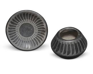 3300
Crucita "Blue Corn" Calabaza (1921-1999, San Ildefonso Pueblo)
Two blackware pottery vessels, mid-20th century
Each incised to underside: Blue Corn / San Ildefonso Pueblo
Each with black on black banded feather motif, comprising a small jar and a small dish
2 pieces
Jar: 2" H x 3" Dia.; Dish:1.125" H x 5" Dia.
Estimate: $1,000 - $1,500