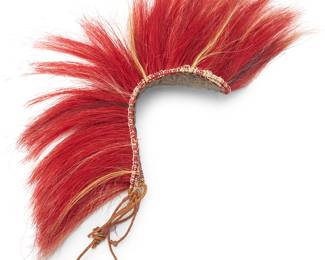 3247
A Northern Plains roach headdress
Early/mid-20th century; Great Plains/Northern United States/Canada
A long headdress composed of dyed red animal hair, likely horse or deer tail hair, all stitched to twine laces, and attached to a felted fabric base
7" H x 2.5" W x 10.25" D
Estimate: $300 - $500
